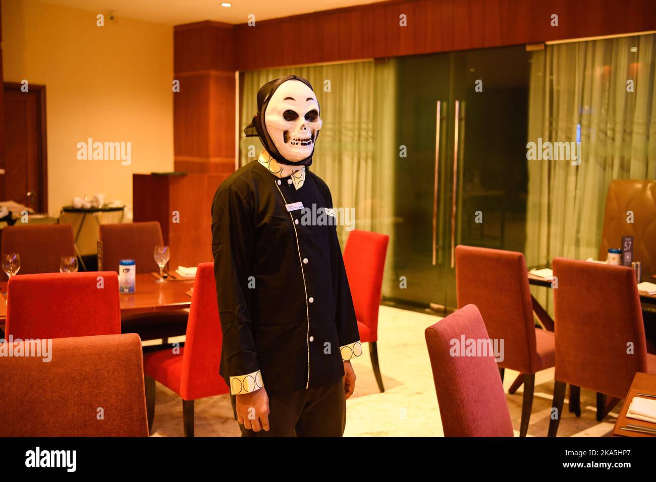 A worker wearing a costume poses for a photo in Dhaka. Halloween or