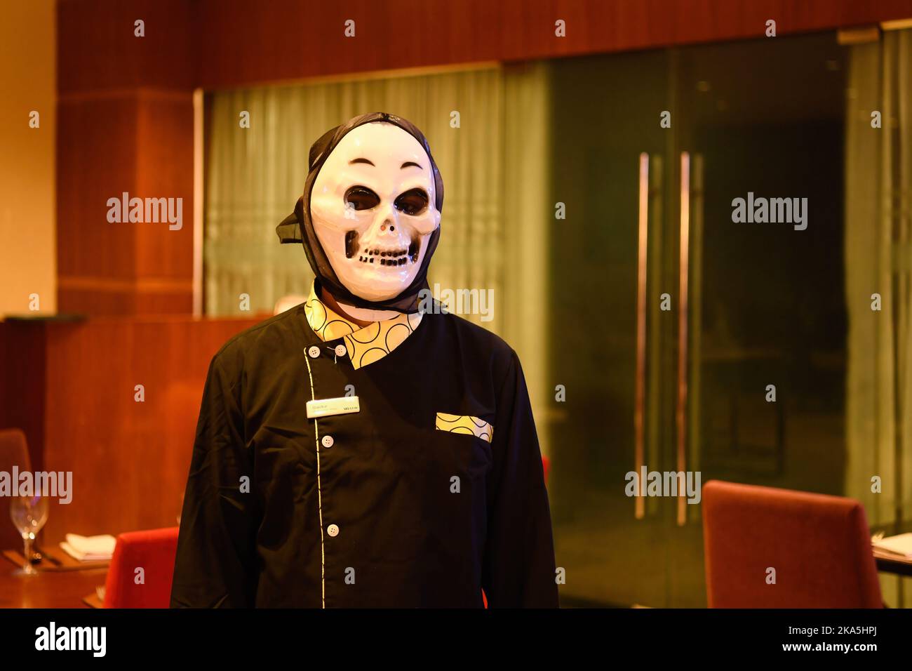 A worker wearing a costume poses for a photo in Dhaka. Halloween or