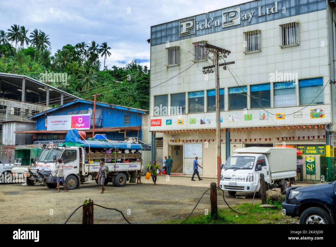 Small vans and trucks parked outside shopping centre. Alotau, Milne Bay Papua New Guinea Stock Photo