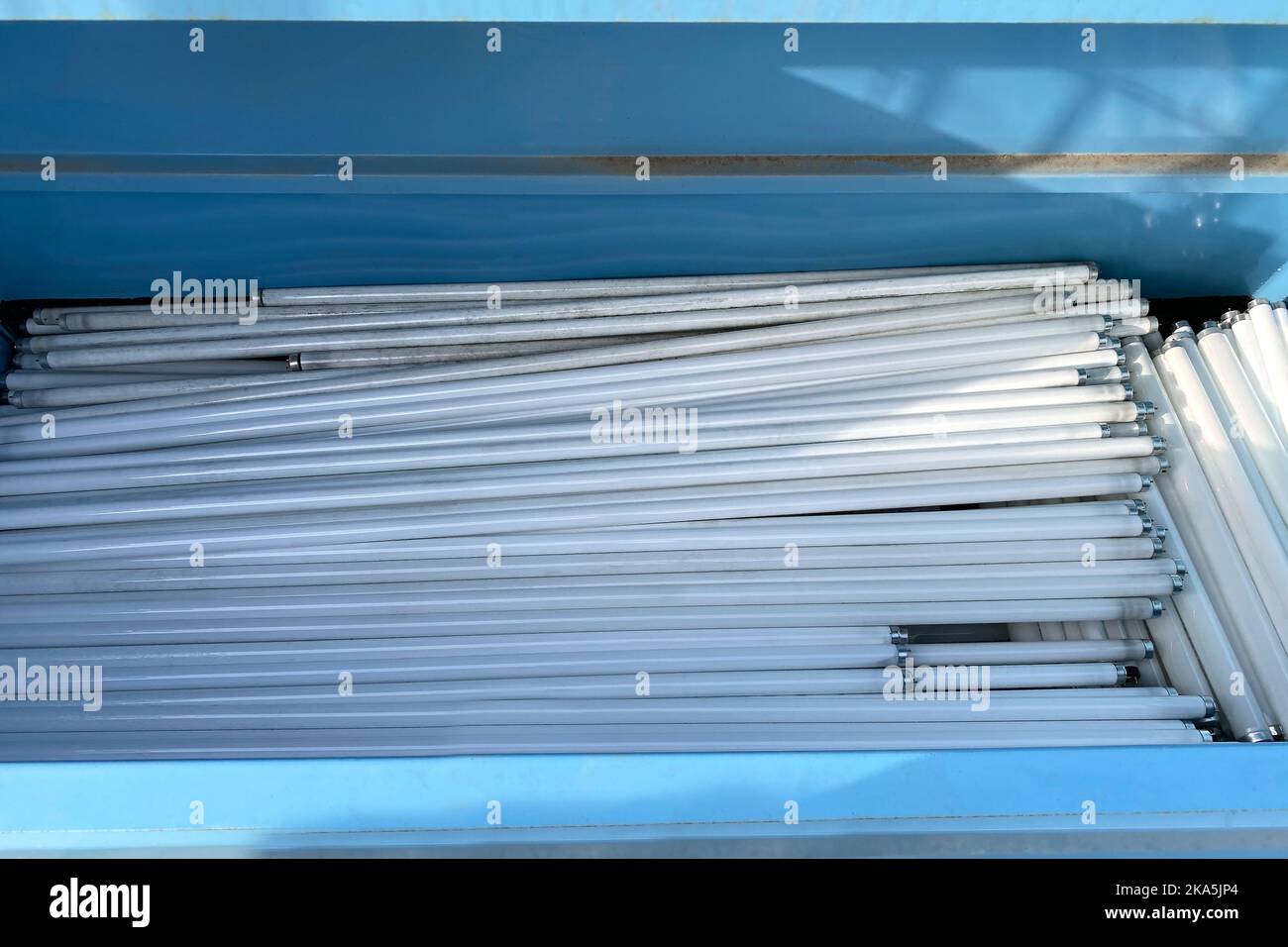 Heap of Uld used Fluorescent light tube lamps in dump trash, recycled