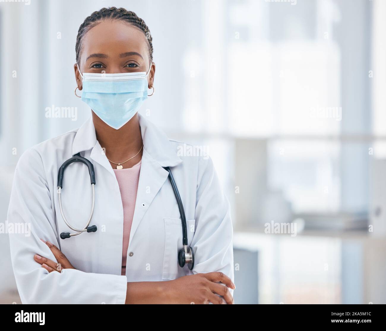Covid, doctor and confident black woman in healthcare in face mask, leadership mindset and success in medicine. Safety, vision and woman medical Stock Photo