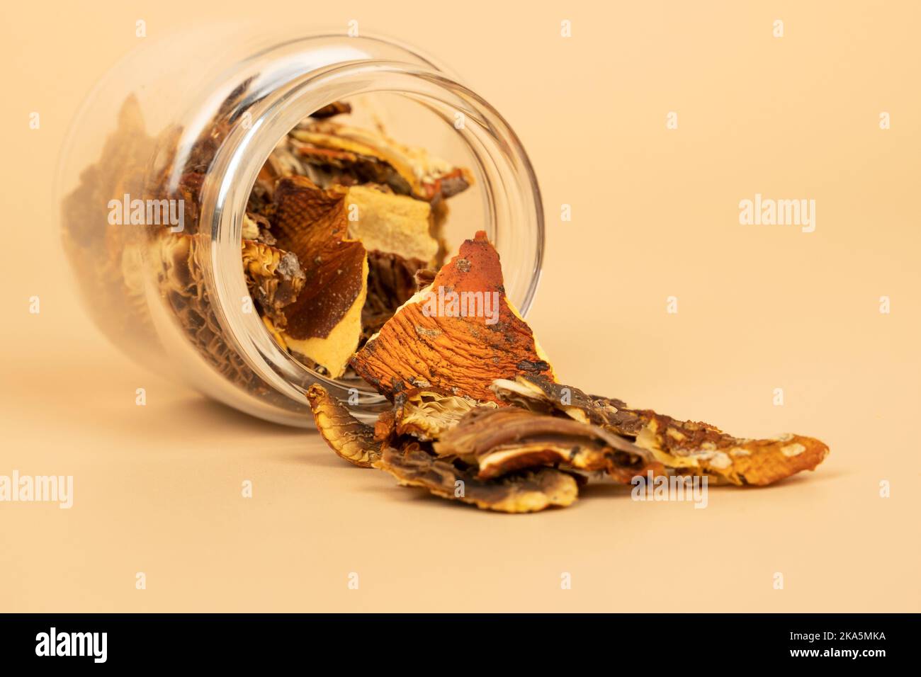 red dried fly agaric in a jar for shamanic rituals and deep trips, natural muscarine mushrooms for microdosing. Stock Photo