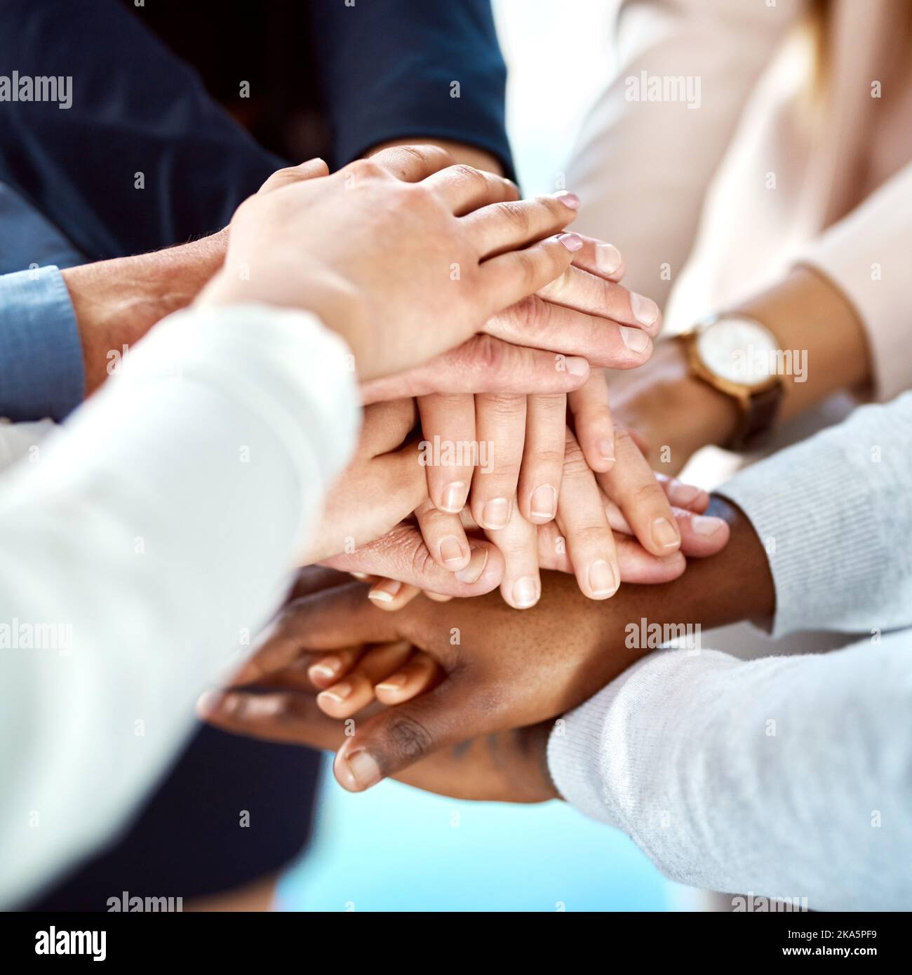 This is to ur fantastic team. a group of unrecognizable people forming a huddle with their hands inside of the office during the day. Stock Photo