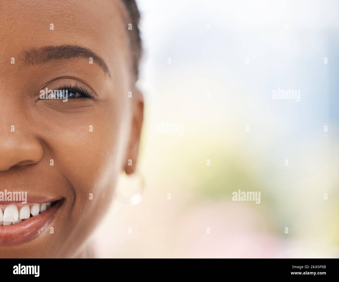 Portrait of half face, black woman and smile with skincare beauty