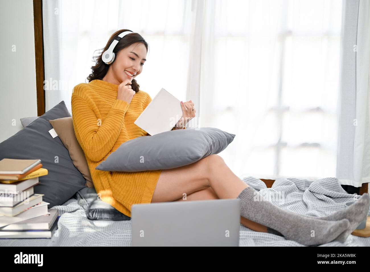 Attractive millennial Asian woman in casual comfy clothes and 