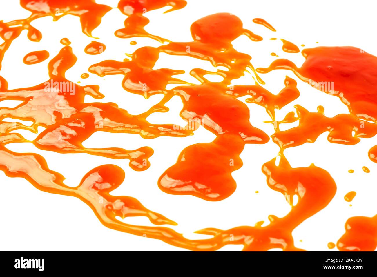 Orange sauce splashes isolated on white a background. Top view. Stock Photo