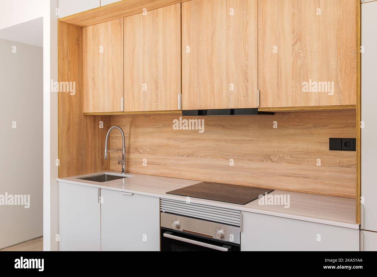 Modern kitchen interior with wooden cabinets, oven and stove with ...