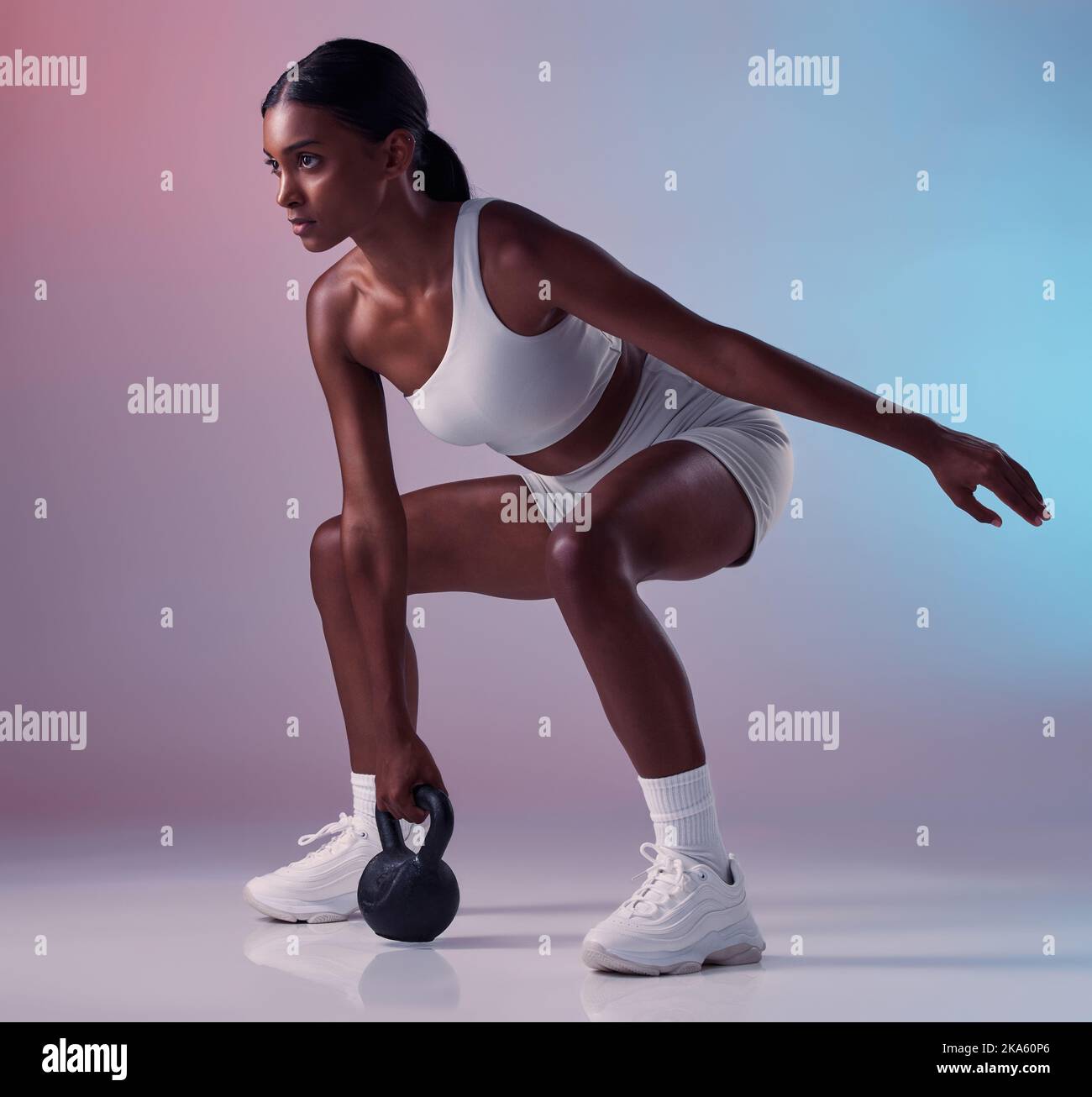 Fitness, exercise and woman with a kettlebell in studio strength