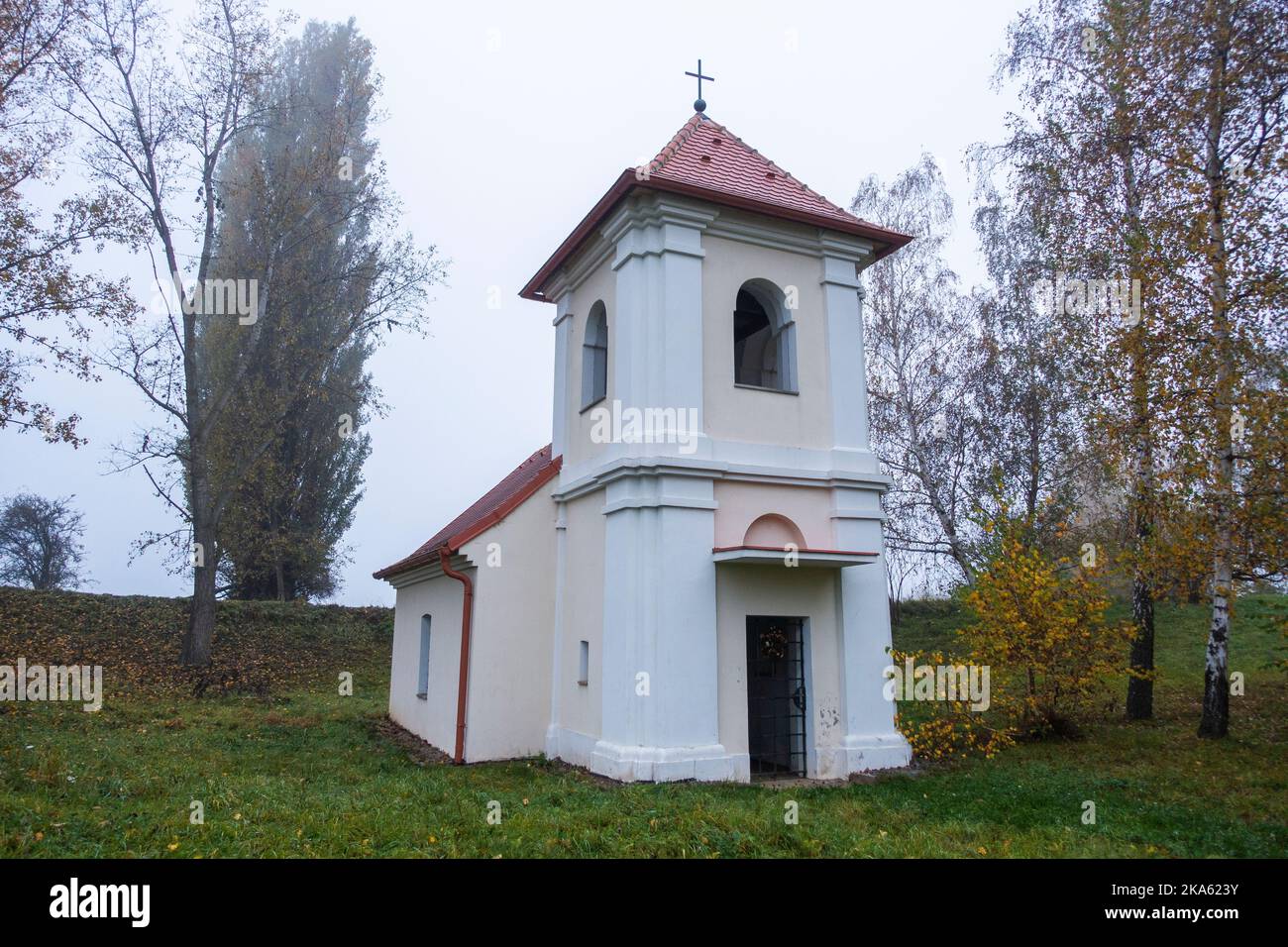 Chapel of the Nativity of the Virgin Mary at the site of the extinct village of Hermanice in thick fog near the Nuclear Power Plant Dukovany, older of Stock Photo