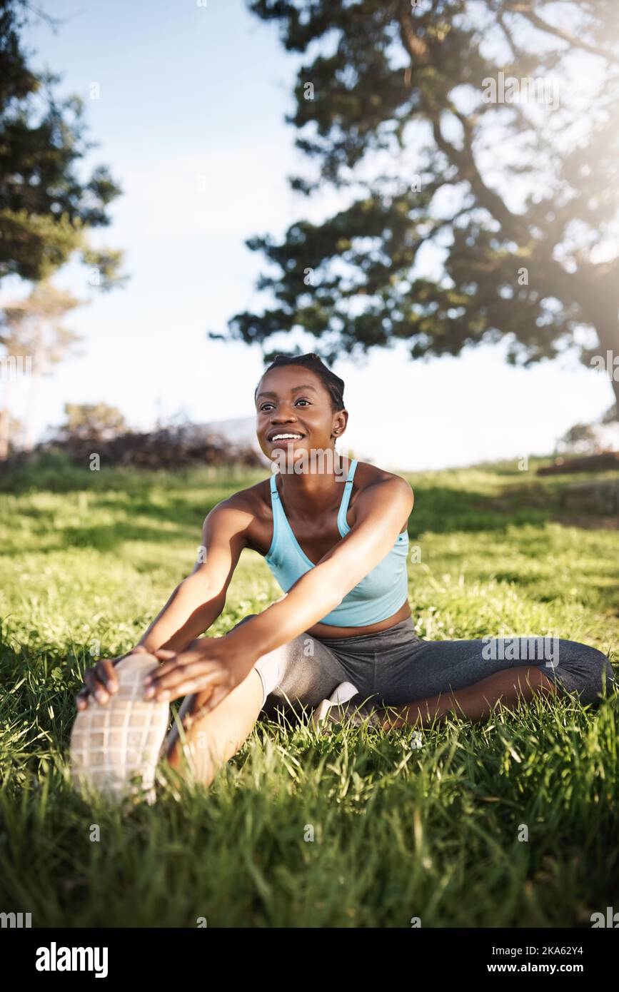 Nothing beats a good workout. a young woman stretching before her run Stock  Photo - Alamy