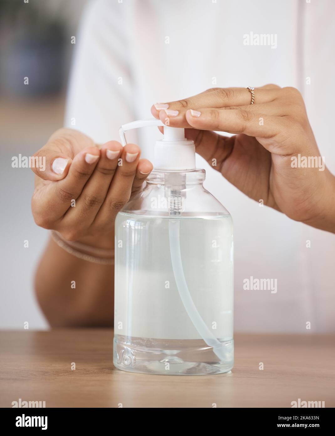 Skincare, safety and hands cleaning bacteria with liquid soap for healthy protection and disinfection. Healthcare, wellness and woman pressing hand Stock Photo