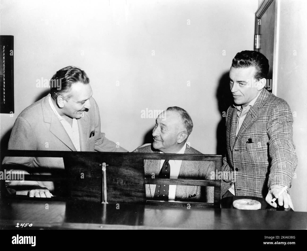 Producer ARTHER FREED at piano with songwriters FREDERICK LOEWE and ALAN JAY LERNER on set candid during production of GIGI 1958 director VINCENTE MINNELLI based on novella by Colette screenplay / lyrics Alan Jay Lerner music Frederick Loewe Metro Goldwyn Mayer Stock Photo