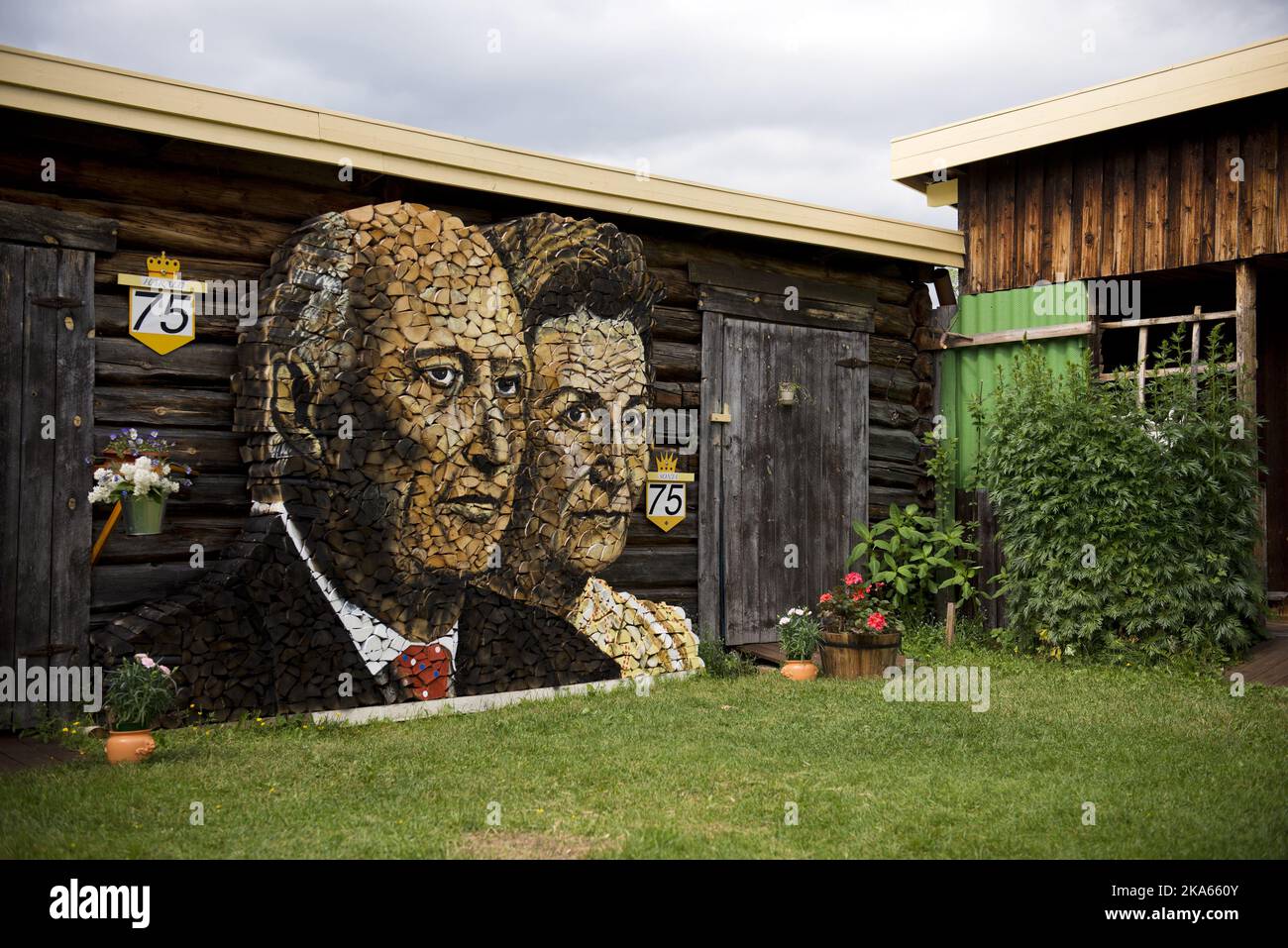 This winter Ole Kristian Kjelling (80) and his wife Zofia will be kept warm by King Harald and Queen Sonja of Norway. A month ago he started the task of stacking firewood into a portrait of the royal couple. It took 6-7 wheelbarrow loads, or 200-300 kilos of birch wood to complete the project. - I have painted everything with ordinary oil paints and been working under a tarpaulin for the last month. It is sculpted and then painted. ItÕs a good thing I have the patience of a horse - the weather has not been on my side Stock Photo