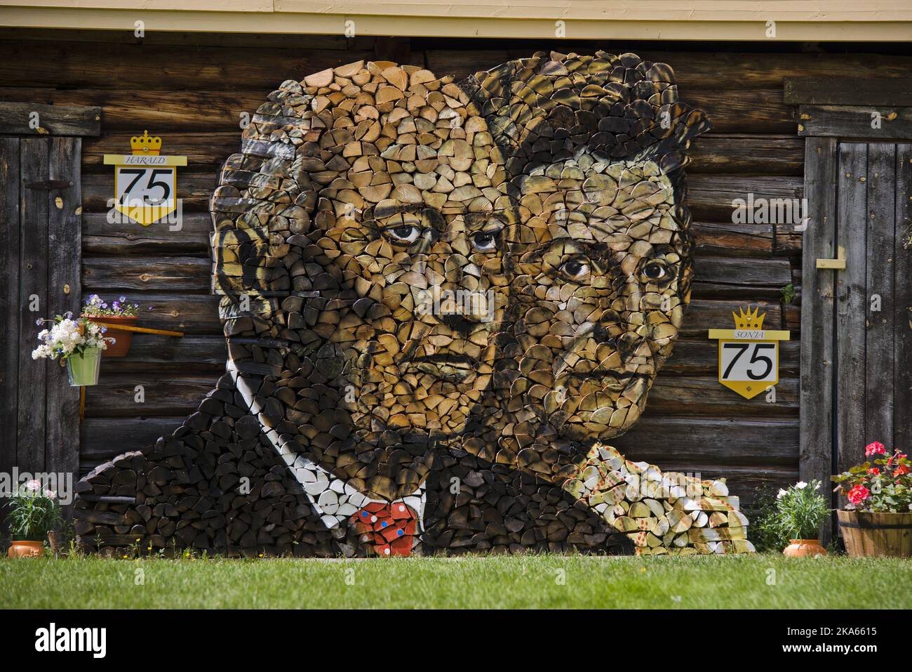 This winter Ole Kristian Kjelling (80) and his wife Zofia will be kept warm by King Harald and Queen Sonja of Norway. A month ago he started the task of stacking firewood into a portrait of the royal couple. It took 6-7 wheelbarrow loads, or 200-300 kilos of birch wood to complete the project. - I have painted everything with ordinary oil paints and been working under a tarpaulin for the last month. It is sculpted and then painted. ItÕs a good thing I have the patience of a horse - the weather has not been on my side Stock Photo