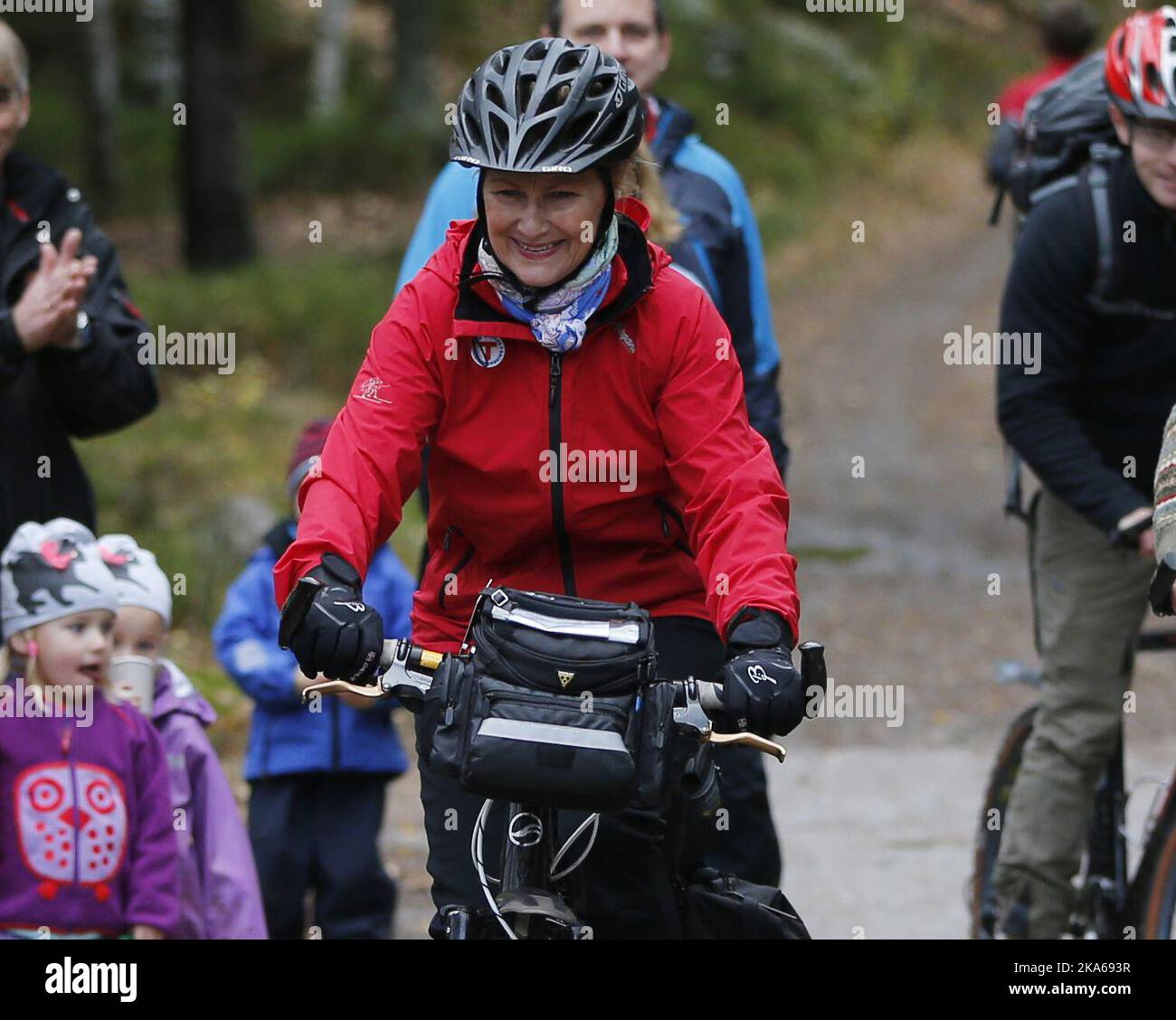 Oslo 20141025. Queen Sonja of Norway attends a ceremony in the woods sourrounding Oslo, where she unveils Oslo's geographic center, marked by a monument by the artist Jon Gundersen. The sporty Queen got there by using her bike. Mayor of Oslo, Fabian Stang, was the the QueenÂ´s host. Photo: Lise Aserud / NTB scanpix  Stock Photo
