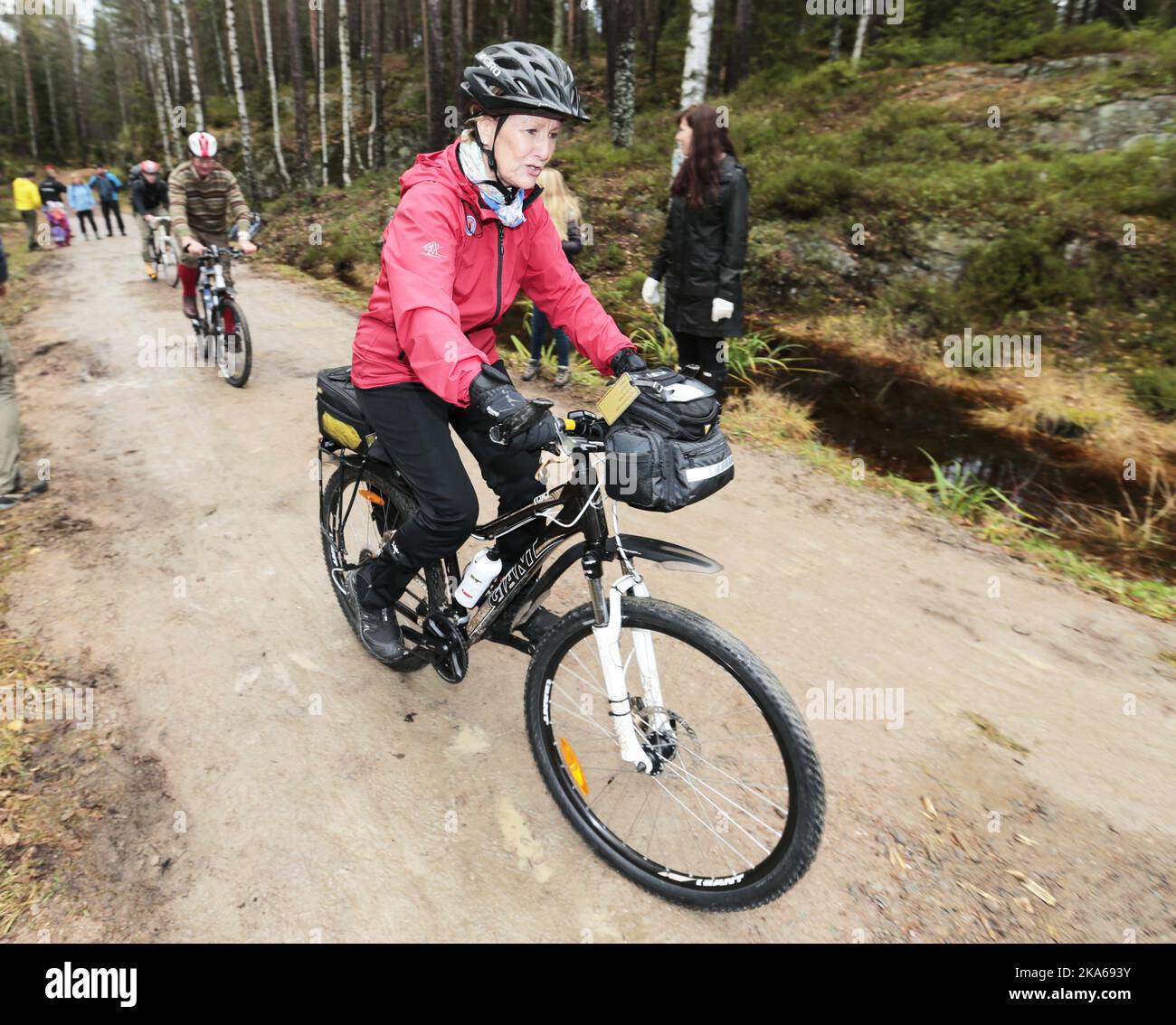 Oslo 20141025. Queen Sonja of Norway attends a ceremony in the woods sourrounding Oslo, where she unveils Oslo's geographic center, marked by a monument by the artist Jon Gundersen. The sporty Queen got there by using her bike. Mayor of Oslo, Fabian Stang, was the the QueenÂ´s host. Photo: Lise Aserud / NTB scanpix  Stock Photo