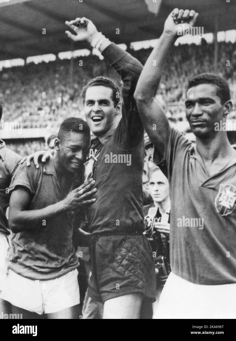 FILE - In this June 29, 1958 file photo Brazil's 17 year-old Pele, left, weeps on the shoulder of goalkeeper Gilmar Dos Santos Neves, after Brazil's 5-2 victory over Sweden in their World Cup final soccer match, in Stockholm, Sweden. Brazil's Didi is at right. On this day: Brazil wins it first World Cup with Pele scoring twice. (AP Photo/File) Stock Photo