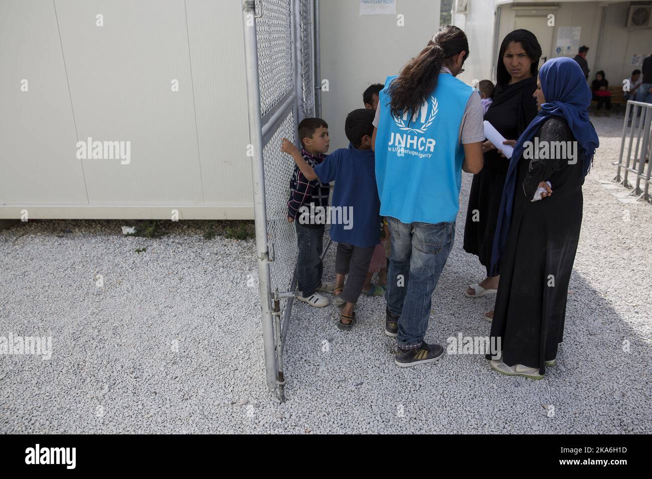 A UNHCR staffer helps with the papers at the Registration Center at Moria camp in Lesbos, Greece on April 19, 2016. The residents are kept behind high fences and barbed wires and they can not leave the as they please. Photo: Tore Meek / NTB scanpix Stock Photo