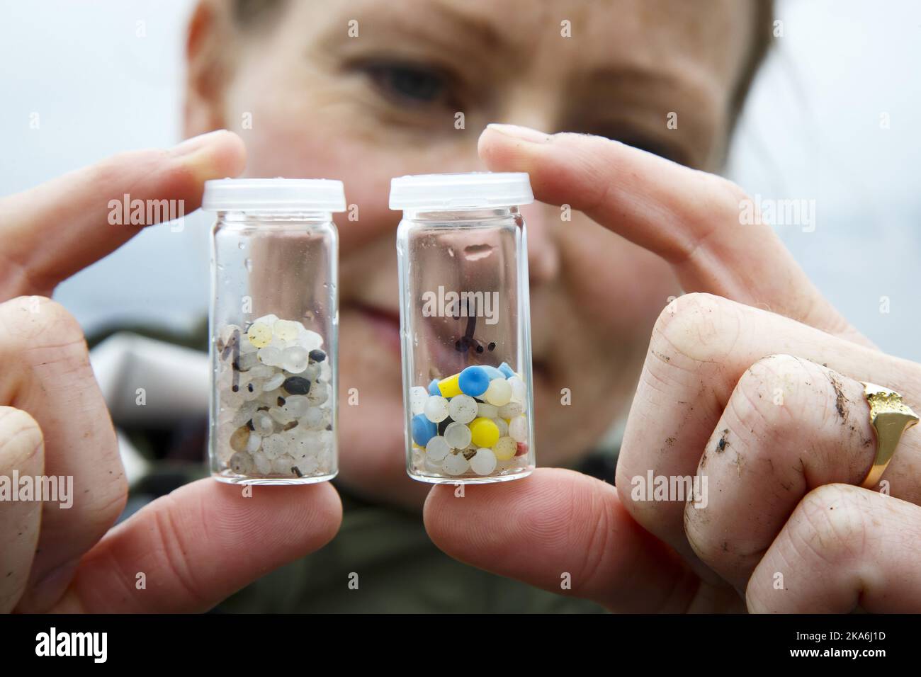 PORSGRUNN, Norway 20160520. Cathrine Nedberg, project manager for the water area in Skien Grenland fjords in Porsgrunn, watching plastic pellets found on Frierstranda (Frier beach) at Heroya in Porsgrunn. The plastic pellets are sent to a laboratory to trace them back to original manufacturing factory. It's plastics industry in Grenland who are the potential emission sources. Photo: Heiko Junge / NTB scanpix Stock Photo