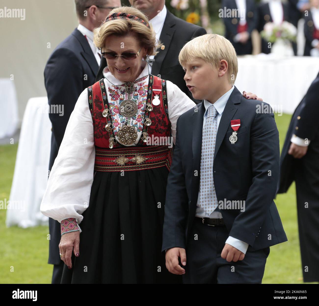 Oslo, Norway 20160901. Their Majesties The King and Queen host a garden party for 1 500 guests in the Palace Park. Queen Sonja with Prince Sverre Magnus when the garden party is almost over. The Queen and the Prince wears Kong Harald Vs jubileumsmedalje 1991Â–2016 ( King Harald V's Jubilee medal 1991-2016) . Photo: Lise Aaserud / NTB scanpix Stock Photo