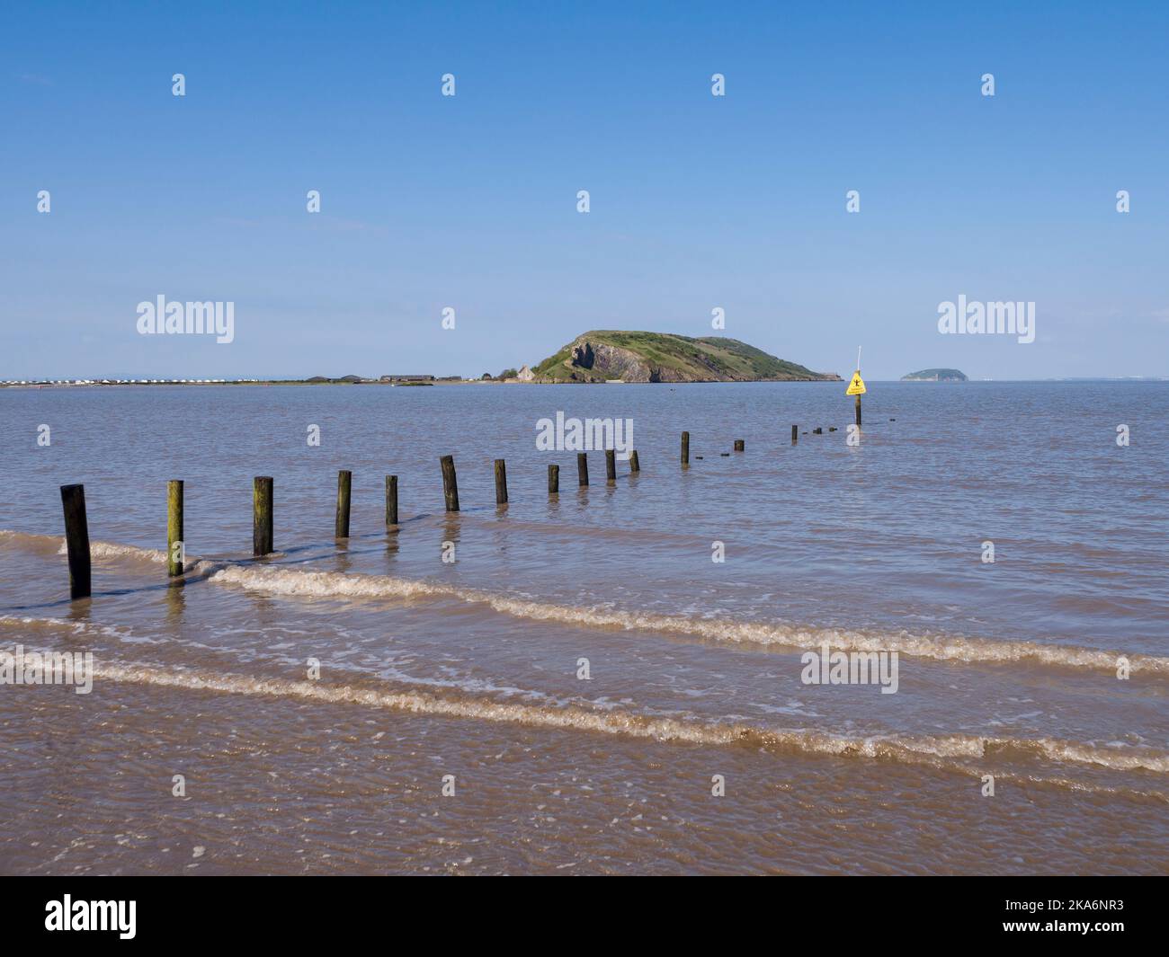 The beach at Uphill during high tide with Brean Down beyond, North Somerset, England. Stock Photo