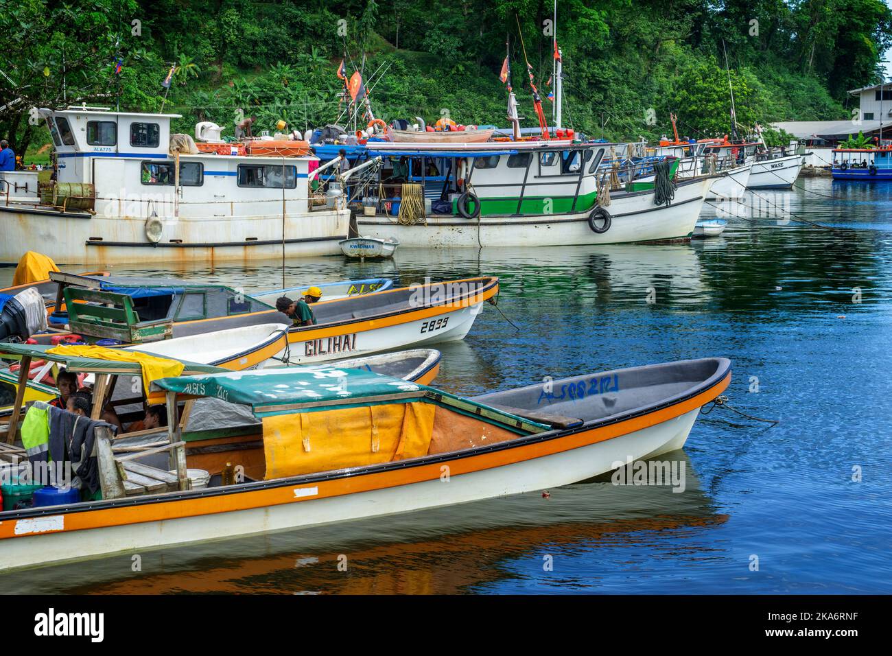 Boats anchored in marina Alotau, Milne Bay Papua New Guinea Stock Photo