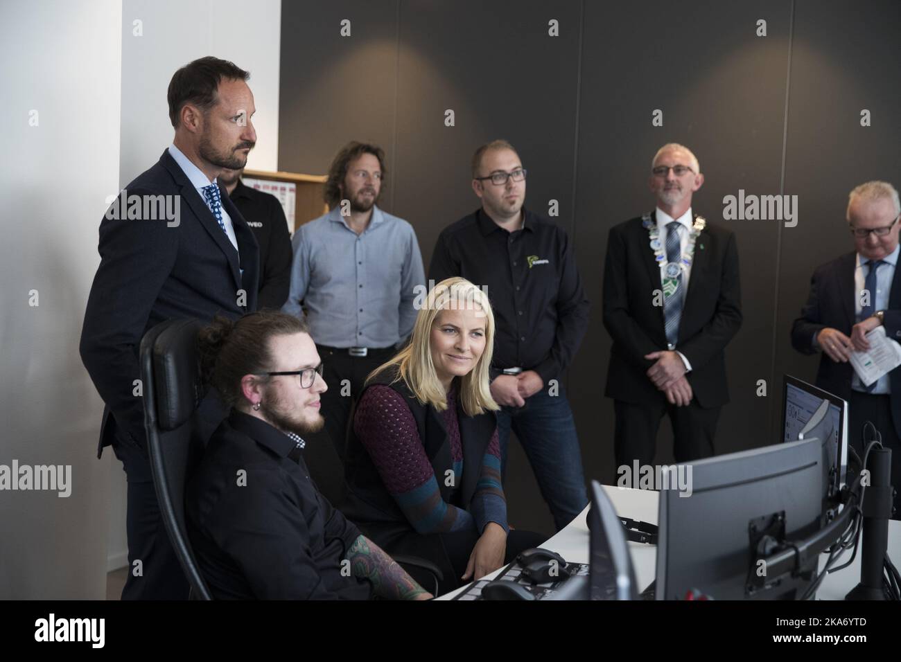 FLATANGER, Norway 20170921. The Crown Prince Couple's county trip to Nord-Troendelag 2017. Crown Prince Haakon and Crown Princess Mette-Marit are welcomed by the initiator of the Havbruksparken and one of the owners of the property company, Per Anton Loefsnaes (right). Then the Crown Prince Couple went to the pre-inspection station on Bjoeroya AS. Production Manager Marius Olsen (left) inform about feeding farmed salmon via remote control. Photo: Berit Roald / NTB scanpi Stock Photo