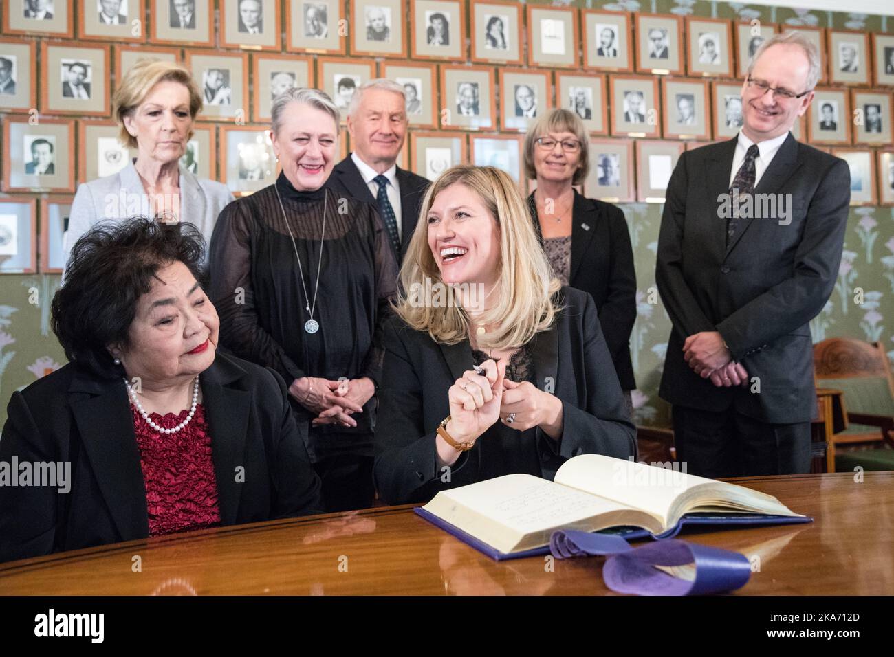 Oslo, Norway 20171209. Nobel Peace Prize 2017 to International Campaign to Abolish Nuclear Weapons (ICAN). Director of Peace Prize winner ICAN, Beatrice Fihn, signs the protocol at Nobel Institute Saturday. To the left Hiroshima survivor Setsuko Thurlow. Back from left: Inger-Marie Ytterhorn, Berit Reiss-Andersen, Thorbjørn Jagland, Tone Joerstad and Henrik Syse from the Nobel Committee. Photo: Audun Braastad / NTB scanpi Stock Photo