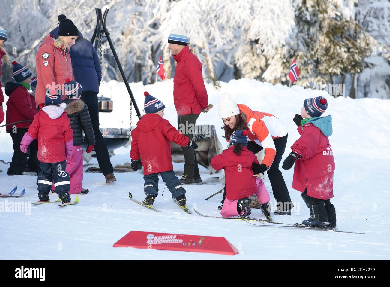 Oslo, Norway 20180202. Prince William of Great Britain and Duchess Kate visits Oevresetertjern at Tryvann in Oslo as the last point of the program on their official visit to Norway. Here they can see skiing activities at a ski school and visit the Tomm Mustad open-air nursery school. Duchess Kate helps a child on skies. Crown Princess Mette-Marit to the left.. Photo: Haakon Mosvold Larsen / NTB scanpi Stock Photo