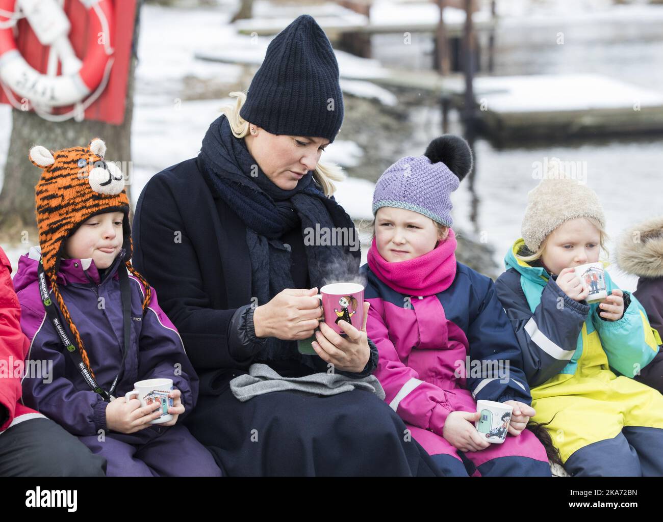FREDRIKSTAD, Norway 20180215. Crown Princess Mette-Marit meets twelve kindergarten children from the Smertulia kindergarten and had ar mug of hot cocoa with them. Crown Princess Mette-Marit got a Moomin mug that she wanted to keep in her office. From left: Marius, Crown Princess Mette-Marit, Le and Andrea. Photo: Berit Roald / NTB scanpix Stock Photo