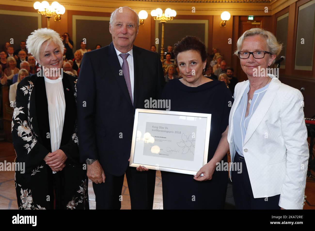 Oslo, Norway 20180416. King Harald presents Professor Vessela Kristensen (UiO) (2nd right) Kong Olav Vs Cancer Research Prize for 2018 at the University's Old Hall Monday. The Cancer Research Prize is awarded by the Cancer Society to researchers who have distinguished themselves through years of efforts for a better life for many people. Photo: Heiko Junge / NTB scanpi Stock Photo