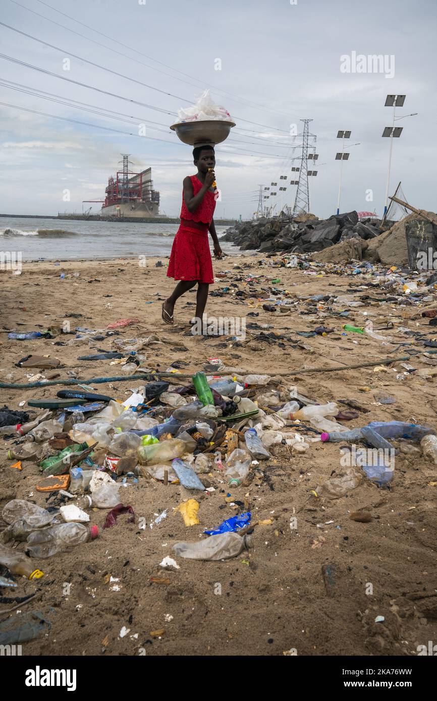 Accra, Ghana 20190601. A girl walks on a ruined beach in the port city