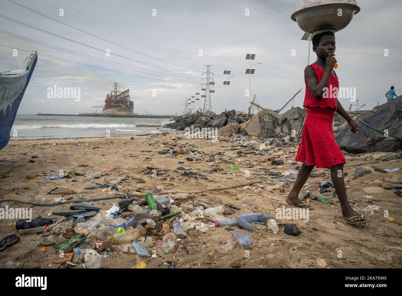 Accra, Ghana 20190601. A girl walks on a ruined beach in the port city