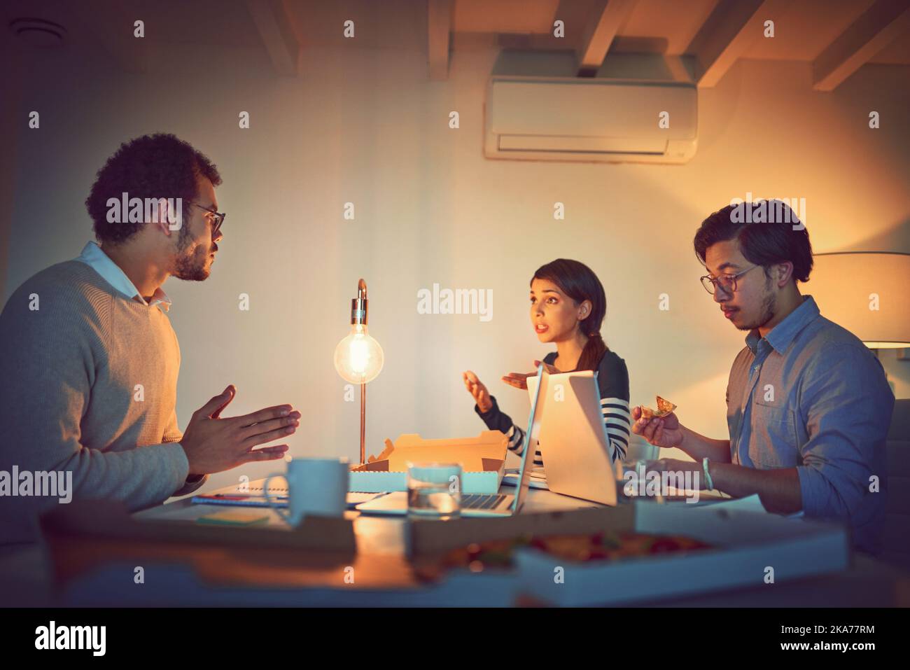 Business through the night. a group of designers working late in an office. Stock Photo