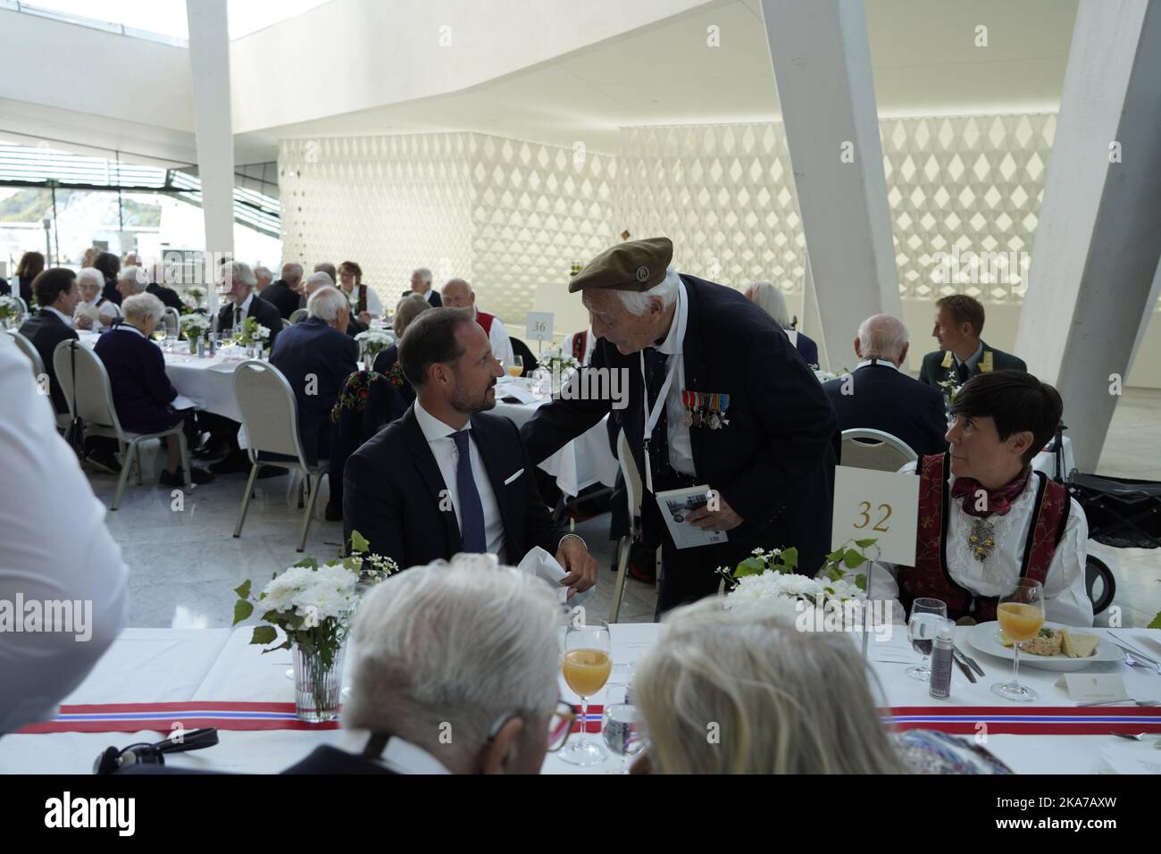 Oslo 20210819. August Rathke in conversation with Crown Prince Haakon and Foreign Minister Ine Marie Eriksen Søreide during the government's lunch for war sailors, veterans and witnesses from World War II at the Opera House in Oslo on Thursday. Last year's 75th anniversary was postponed due to the Corona pandemic. Photo: Heiko Junge / NTB / POOL  Stock Photo