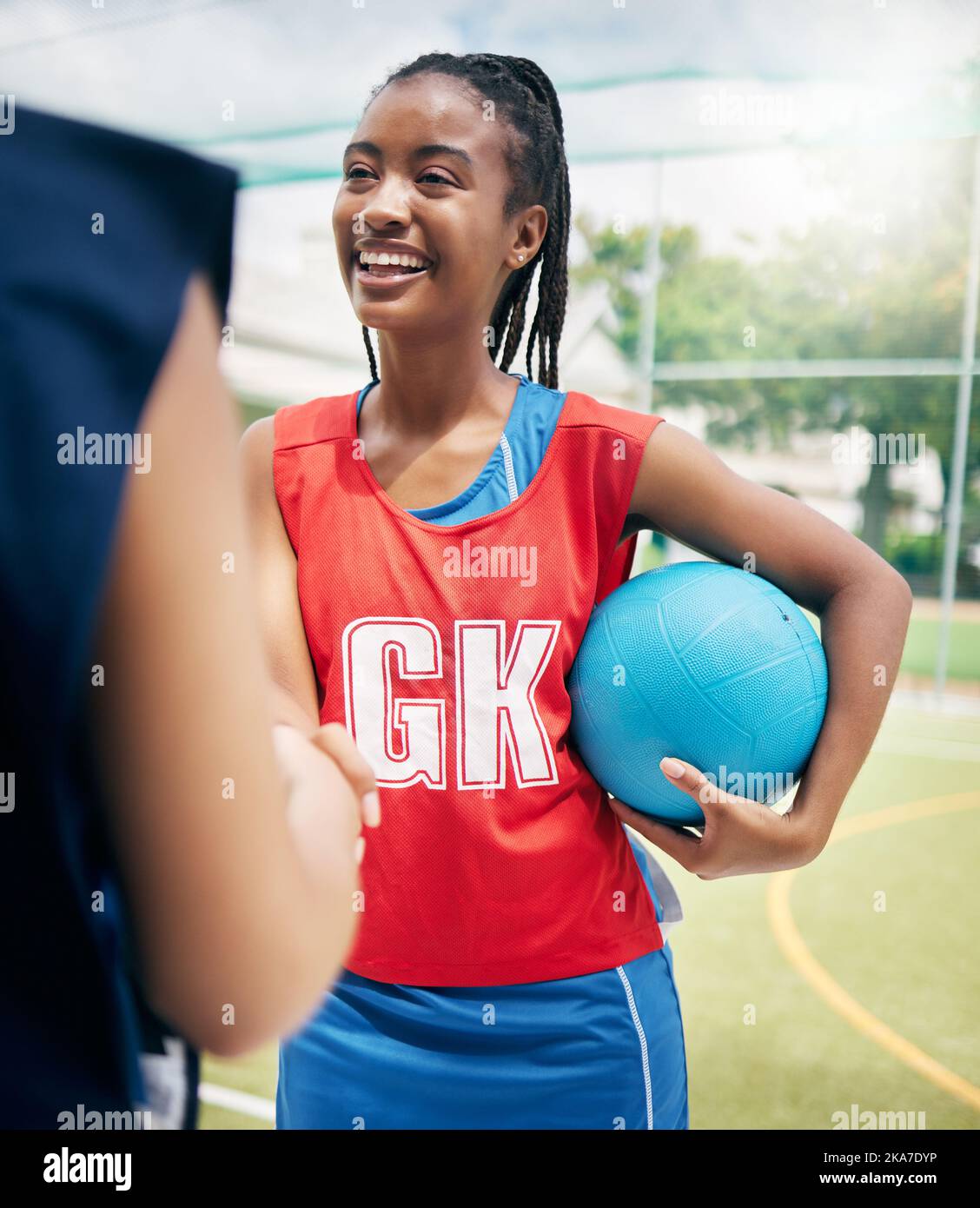 Black woman, netball player and handshake on court in fitness game, workout match or training competition exercise. Smile, happy and sports women in Stock Photo