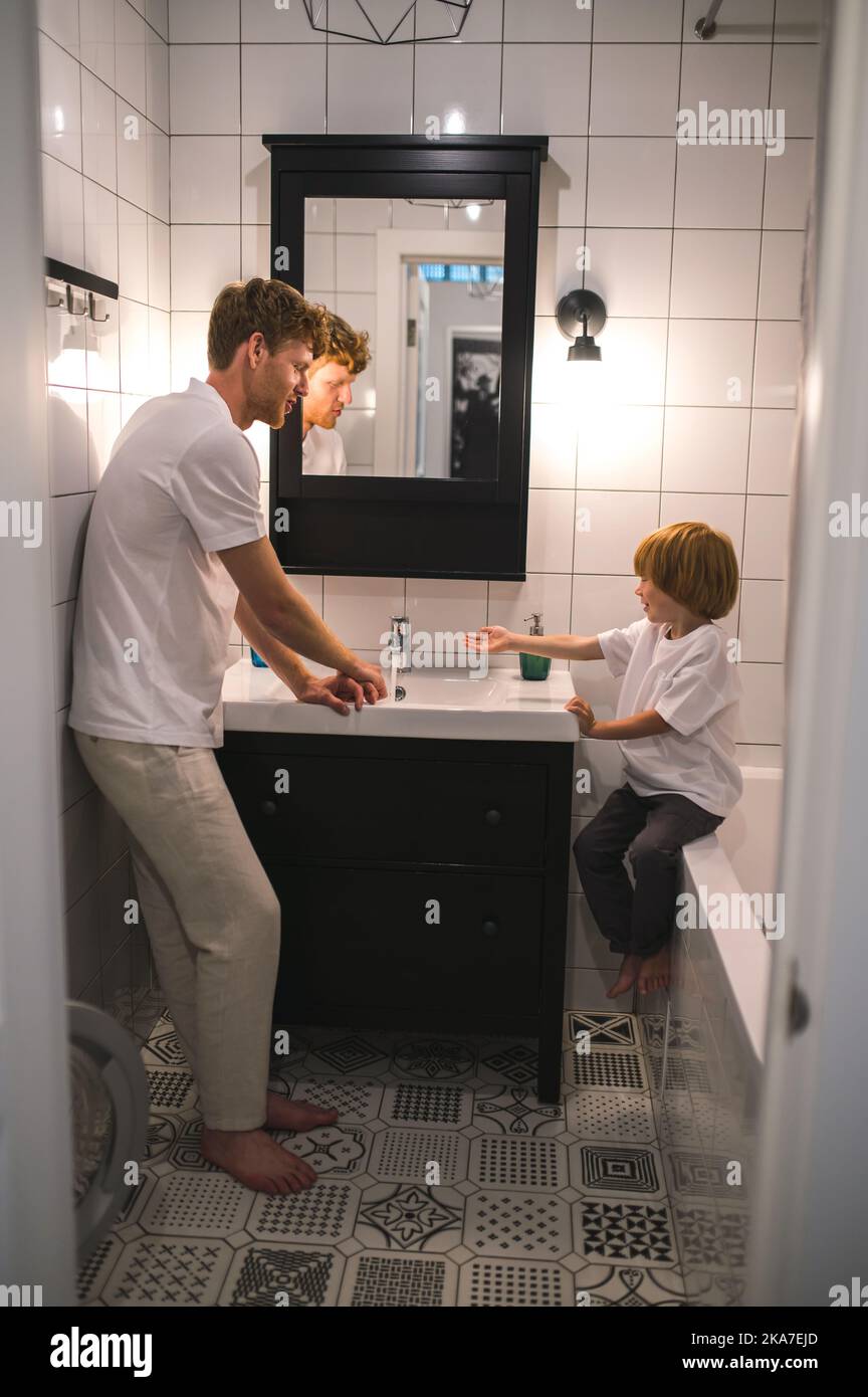 Dad and son in the batheroom getting ther morning procedures done Stock Photo