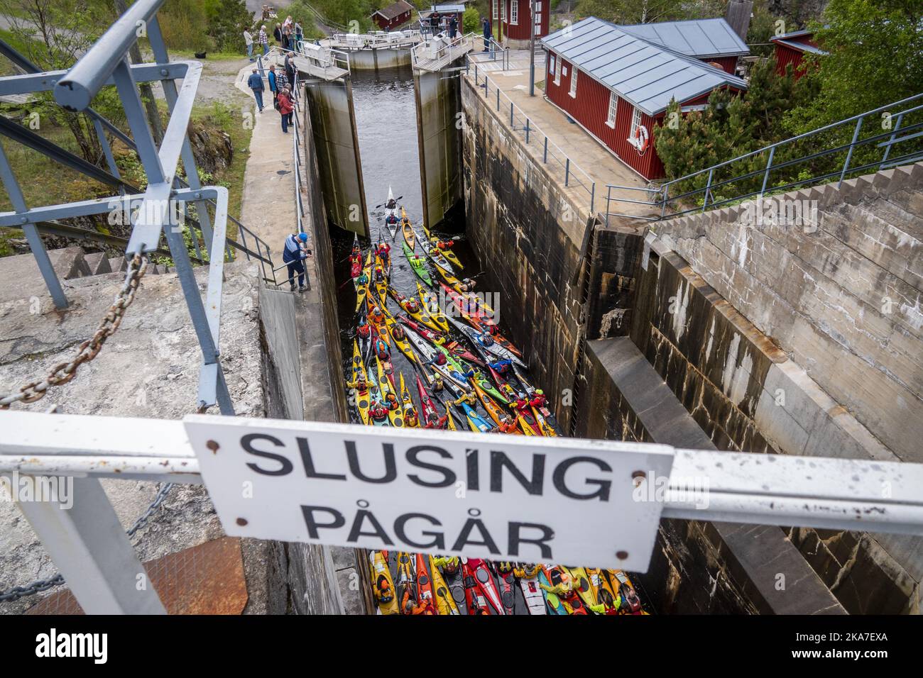 Brekke 20220529. 60 colorful kayaks paddling through the locks of the Halden Canal on Sunday. With its 26.6 m total lifting height in four chambers, Brekke locks are Northern Europe's highest continuous lock staircase. After a two-year pandemic break, there is a record-breaking participation in the annual 57 km long paddle trip from Oerje to Halden. Photo: Heiko Junge / NTB  Stock Photo