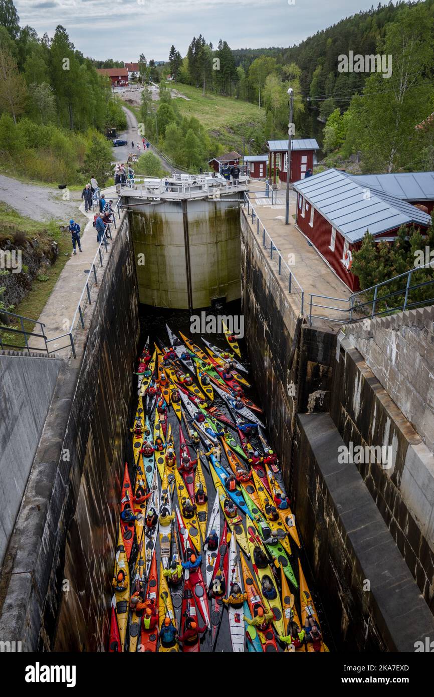 Brekke 20220529. 60 colorful kayaks paddling through the locks of the Halden Canal on Sunday. With its 26.6 m total lifting height in four chambers, Brekke locks are Northern Europe's highest continuous lock staircase. After a two-year pandemic break, there is a record-breaking participation in the annual 57 km long paddle trip from Oerje to Halden. Photo: Heiko Junge / NTB  Stock Photo