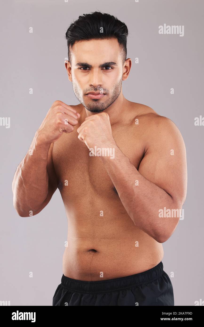 Fist, fight and portrait of an athlete in a studio for sports, MMA or martial arts training. Fitness, defense and strong fighter ready to do a boxing Stock Photo