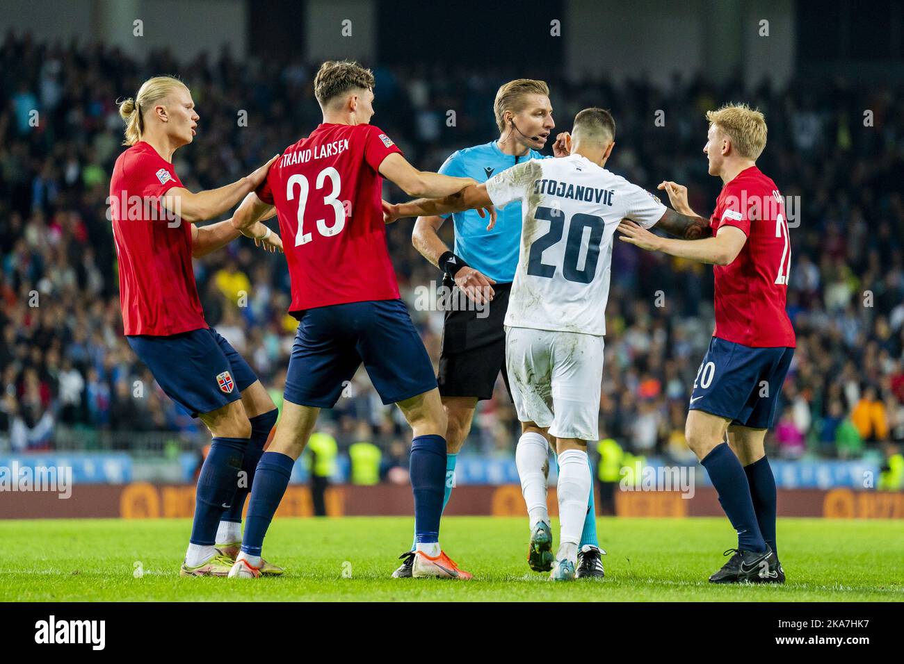Ljubljana, Slovenia 20220924. Norway's Erling Braut Haaland, JÃ¸rgen Strand Larsen and Mats MÃ¸ller DÃ¦hli discuss with referee Lawrence Visser and Slovenia's Petar Stojanovic during the Nations League football match between Slovenia and Norway at Stozice Stadium. Photo: Fredrik Varfjell / NTB  Stock Photo