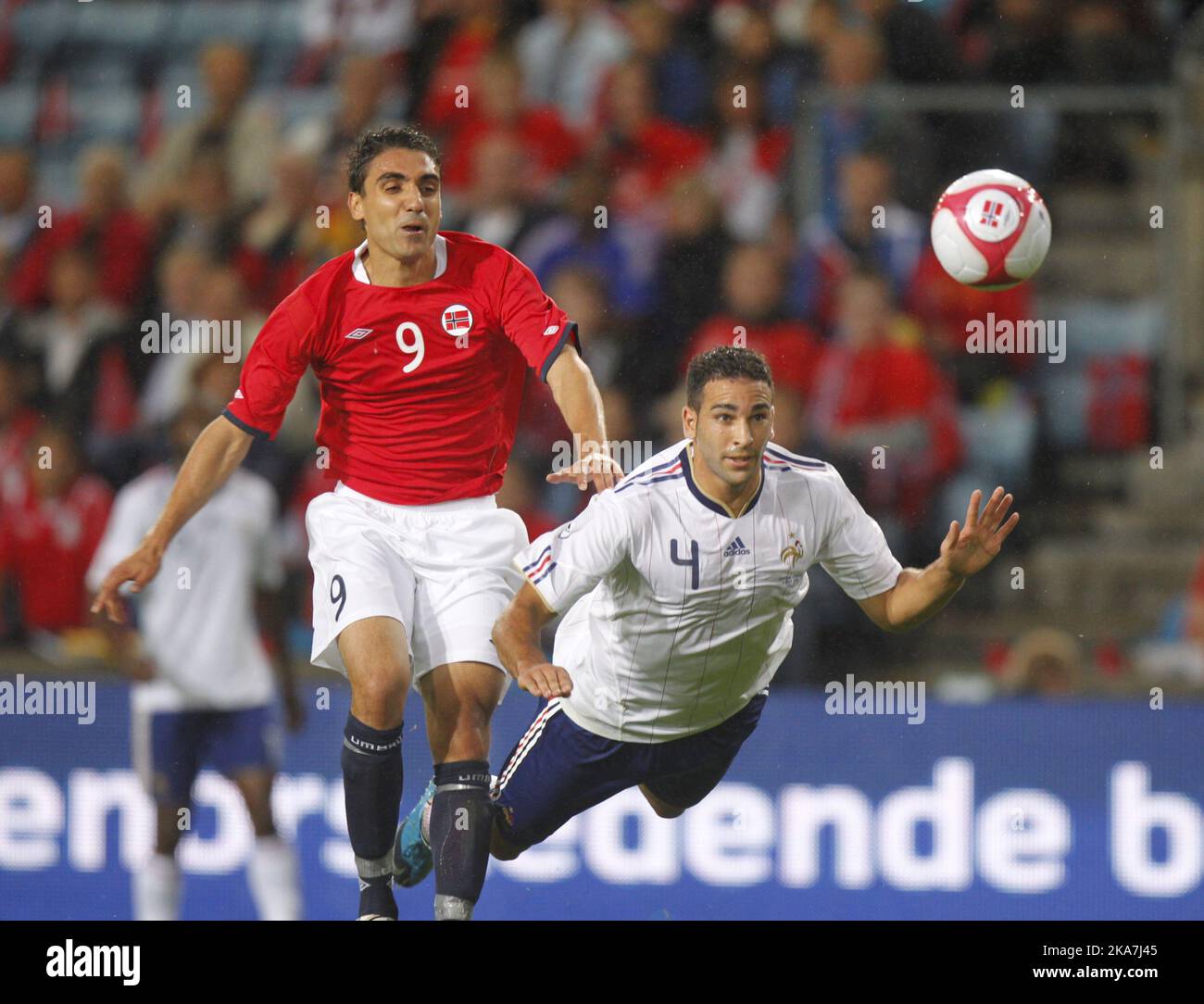 Adil Rami (R) and Mohammed Abdellaoue (L) battle for the ball Stock Photo