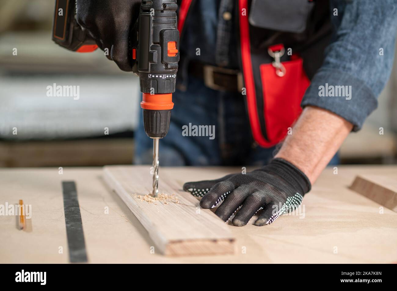 Craft person drlling wood in the workshop Stock Photo