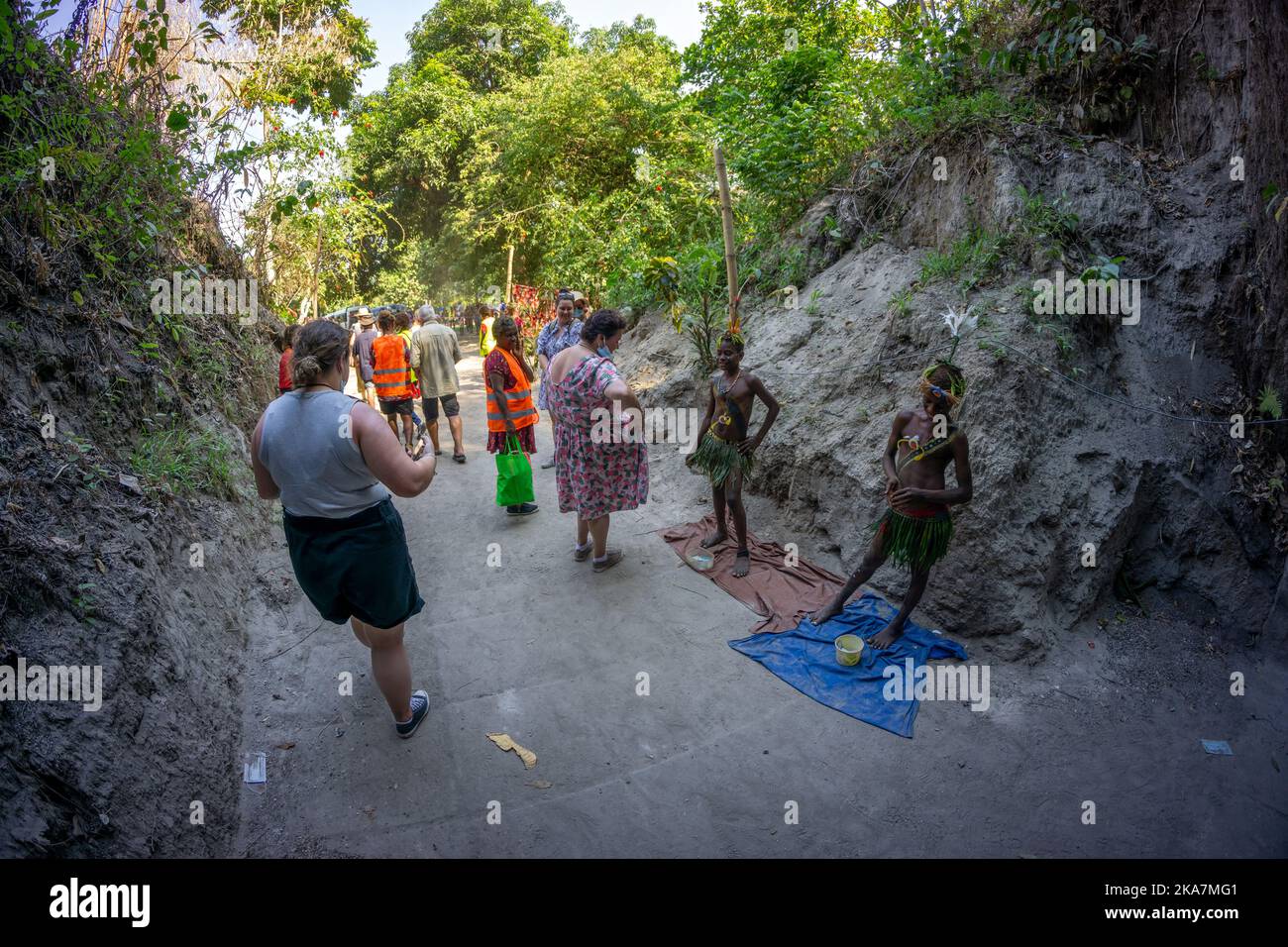 Tourists visiting remains of WWII Japanese transport barge in barge tunnel. Rabual, New Britain