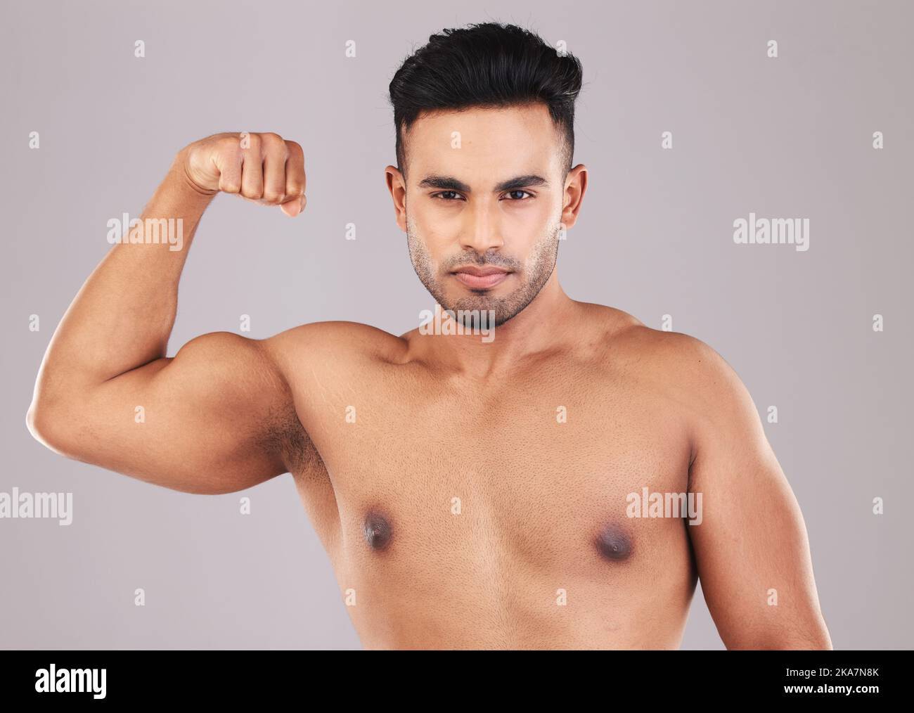 Fitness, portrait and man flexing his bicep for motivation, energy and power in a studio. Wellness, health and athlete from Mexico with strong arm Stock Photo