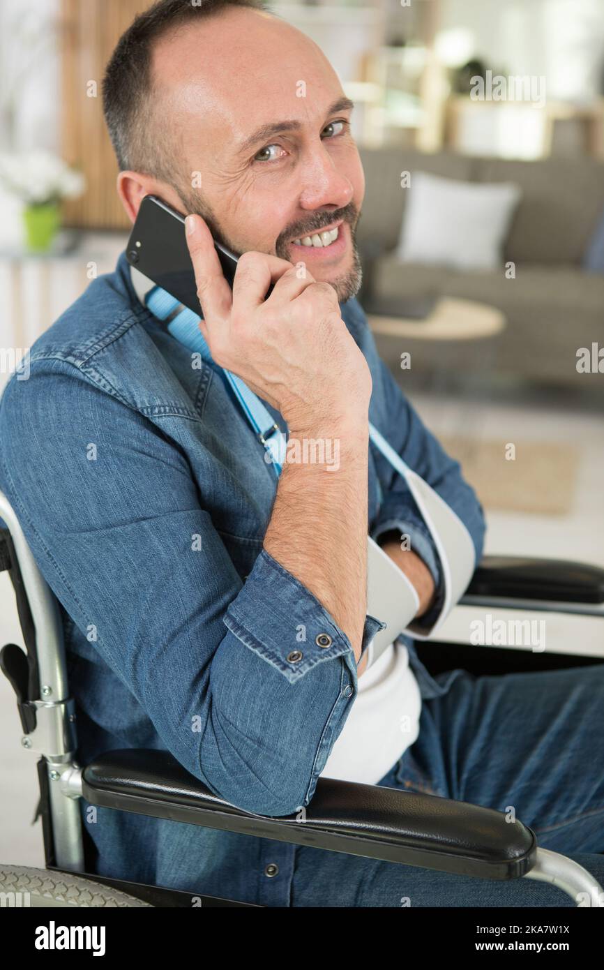 man in wheelchair talking on phone Stock Photo