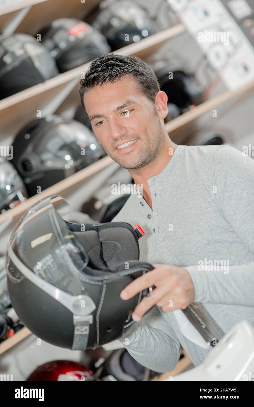 Man shopping for a motorbike helmet Stock Photo