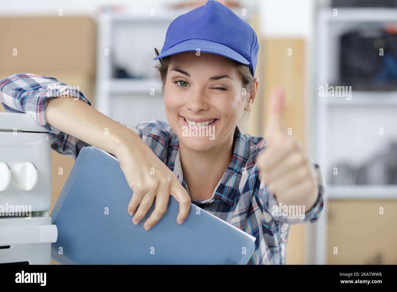 servicewoman winking and holding thumbs up Stock Photo