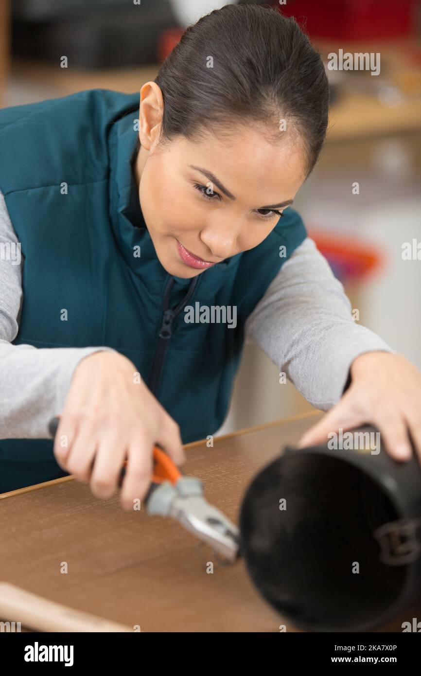 female mechanic using pliers Stock Photo