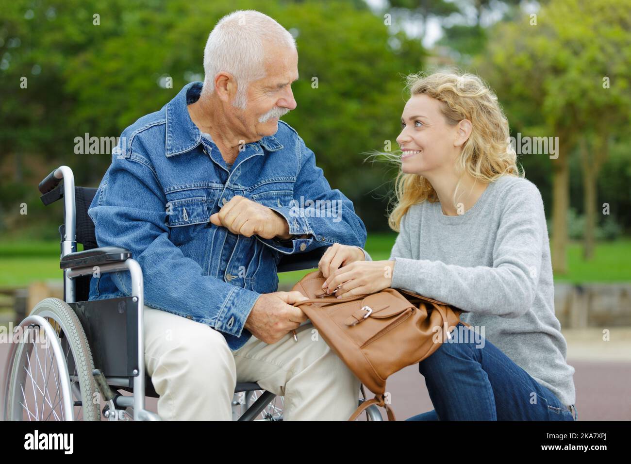 Young man wheelchair bag hi-res stock photography and images - Alamy
